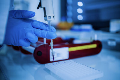 Cropped hand of man holding dental equipment