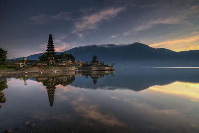 Reflection of building in lake at sunset