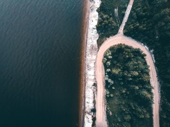 High angle view of stone wall by sea