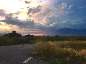 Scenic view of field against sky at sunset