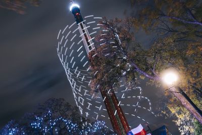 Low angle view of illuminated ferris wheel at night