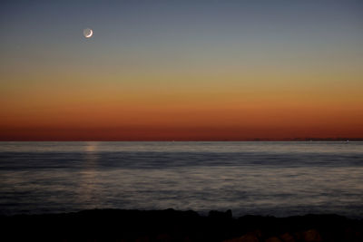 Scenic view of sea against sky at sunset