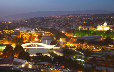 High angle view of illuminated buildings in city at night