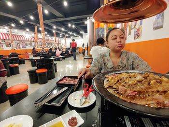 High angle view of woman standing in restaurant