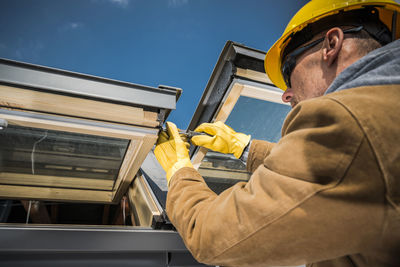 Close-up of worker repairing roof