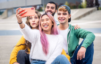 Portrait of smiling young woman using mobile phone