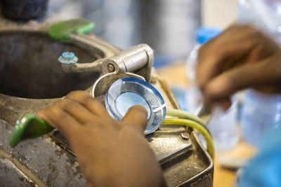 Close-up of man working on metal