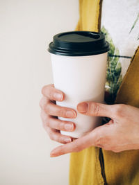 Midsection of woman holding dentures