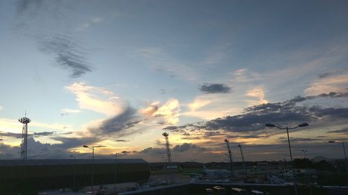 Cars on road against sky during sunset