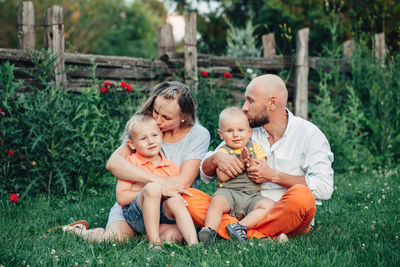 Group of people sitting on grassland