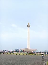 Man in front of historical building against sky