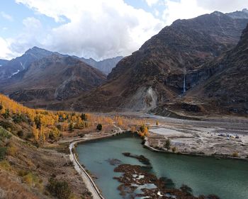 Scenic view of river and mountains against sky