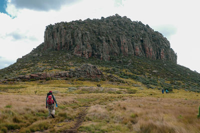 Hikers against rock formations at the mount satima dragons teeth in the aberdares, kenya