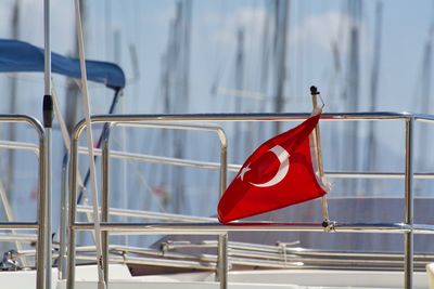 Close-up of flag against boat in sea