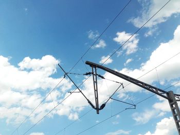 Low angle view of electricity pylon against sky