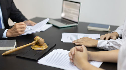 Midsection of business colleagues working in office