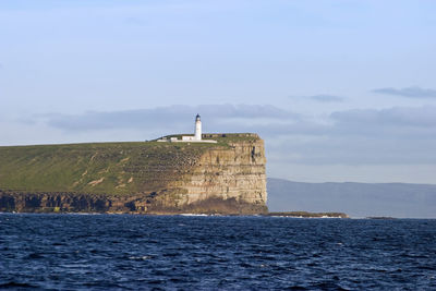 Lighthouse on a rock at the coast.