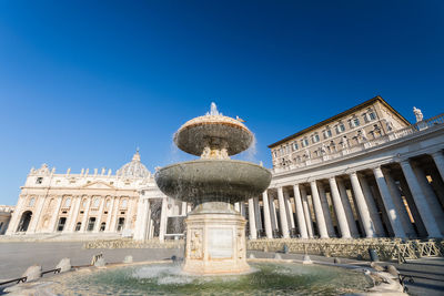 Low angle view of historical building against clear blue sky