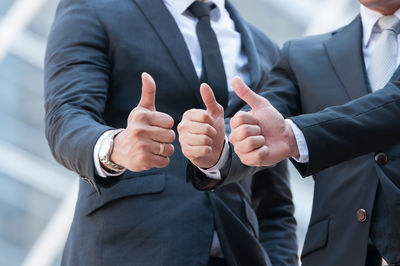 Midsection of man and woman holding hands with text