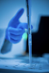 Cropped hand of scientist working at clinic