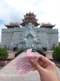 Cropped hand of person holding paper