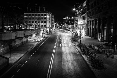 Illuminated city street at night