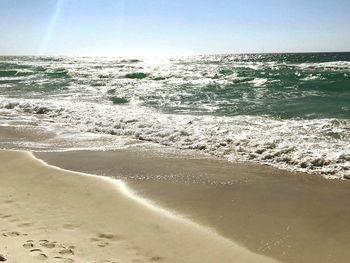 Scenic view of beach against clear sky