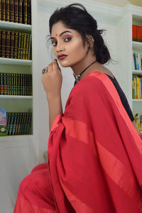 Portrait of beautiful young woman standing at home