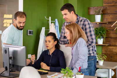 Side view of business colleagues working in office