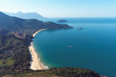 High angle view of sea and mountains against sky