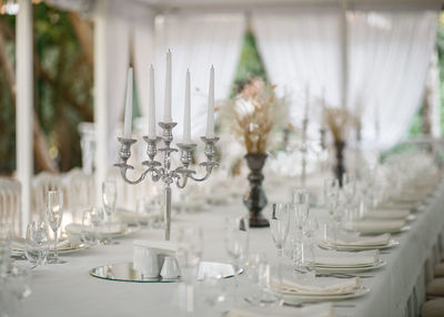 Soft-focus chandelier on white tablecloth. white curtains background.