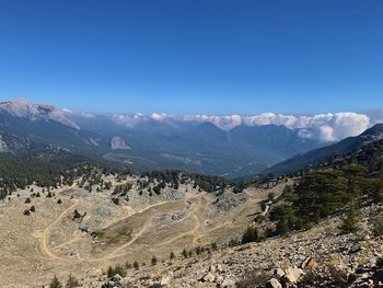 Scenic view of mountains against clear blue sky