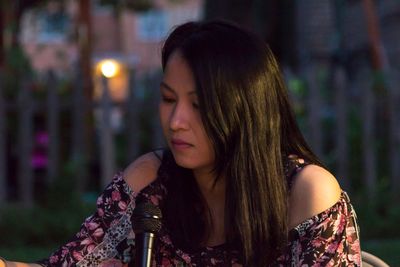 Close-up of young woman with microphone