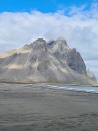 Scenic view of sea and mountains against sky