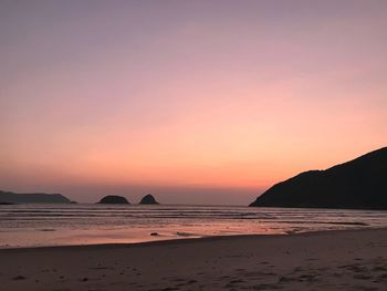 Scenic view of beach against sky during sunset