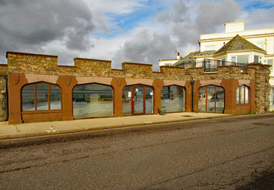 Buildings against cloudy sky