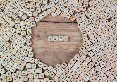 Directly above shot of yoga text amidst wooden cubes