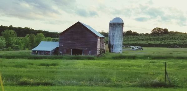 Barn on field against sky