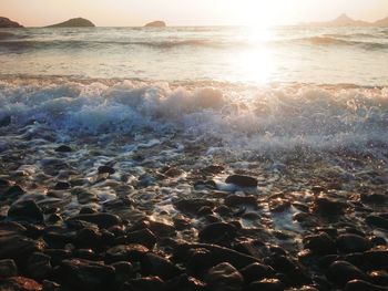 Aerial view of sea and rocks at sunset