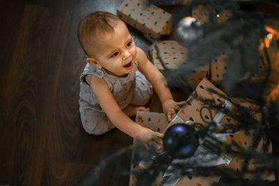 High angle view of boy playing with toy on table