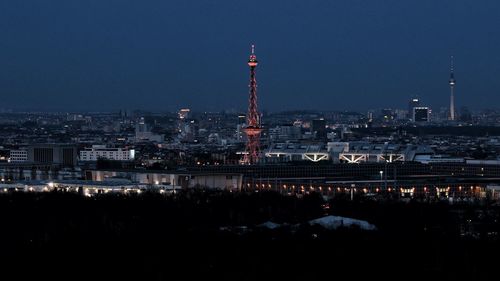 Illuminated cityscape against sky at night