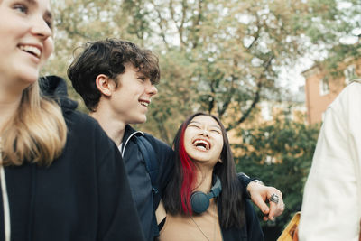 Cheerful male and female teenagers hanging out together