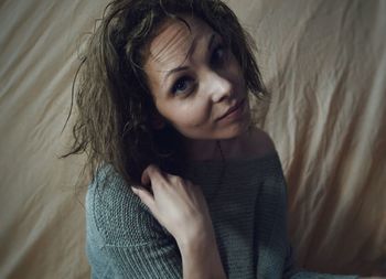 High angle portrait of woman on bed