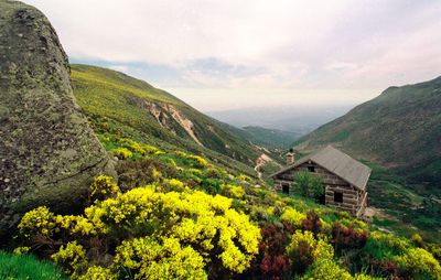 Scenic view of mountains and houses against sky