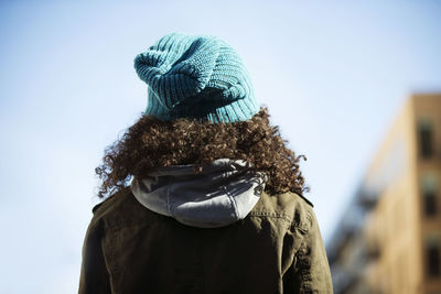 Rear view of woman against sky