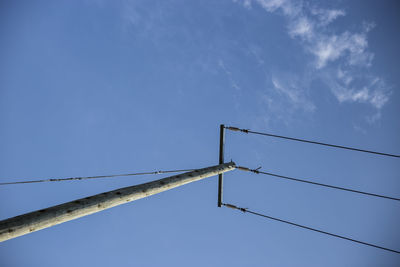 Low angle view of object against blue sky