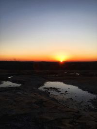 View of snow covered landscape during sunset