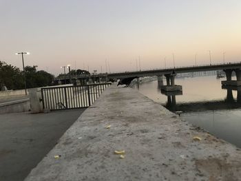 Scenic view of bridge against sky at sunset