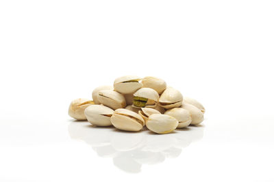 Close-up of pistachios against white background