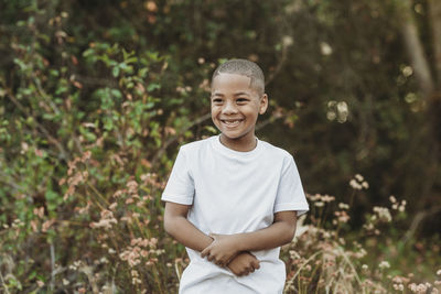 Portrait of smiling boy standing outdoors